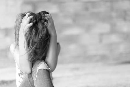 Woman in angle of abandoned building image blur , stop violence against Women, international women's dayの写真素材