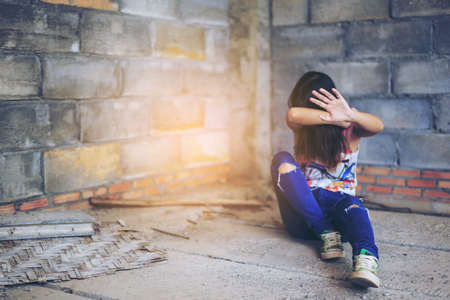 Woman  in angle of abandoned building image blur , stop violence against Women, international women's dayの写真素材