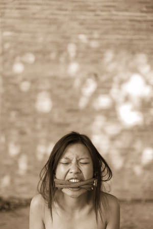 Woman bondage in angle of abandoned building image blur , stop violence against Women, international women's dayの写真素材