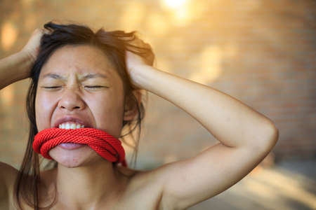 Woman bondage in angle of abandoned building image blur , stop violence against Women, international women's dayの写真素材