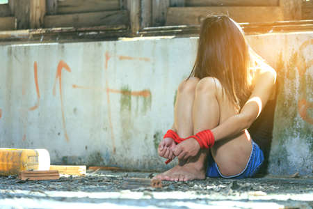 Woman bondage in angle of abandoned building image blur , stop violence against Women, international women's dayの写真素材