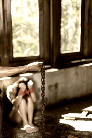 Woman bondage in angle of abandoned building image blur , stop violence against Women, international women's dayの写真素材