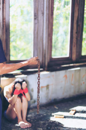 Woman bondage in angle of abandoned building , stop violence against Women, international women's dayの写真素材