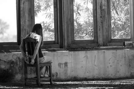 Woman bondage in angle of abandoned building image blur , stop violence against Women, international women's dayの写真素材