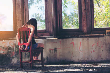 Woman bondage in angle of abandoned building image blur , stop violence against Women, international women's dayの写真素材