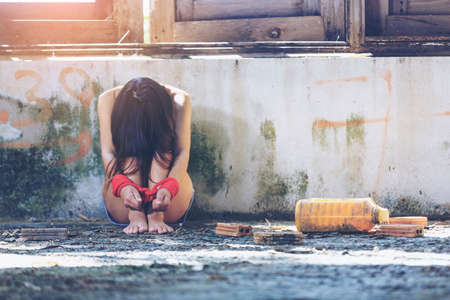 Woman bondage in angle of abandoned building image blur , stop violence against Women, international women's dayの写真素材