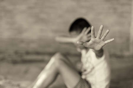 Stop abusing boy Children violence. boy, lad with her hand extended signaling to ,child bondage in...
