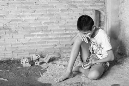 a Boy crying,fear in angle of abandoned building image blur Children violence. boy, lad with her hand extended signaling to Stop,child bondage in angle of abandoned building image blur and pain, afraid, restricted, trapped, call for help, struggle, terrifの写真素材