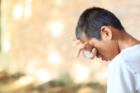 a Boy crying,fear in angle of abandoned building image blur Children violence. boy, lad with her hand extended signaling to Stop,child bondage in angle of abandoned building image blur and pain, afraid, restricted, trapped, call for help, struggle, terrifの写真素材