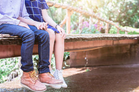 Young couple in love holding hands on the bridge.の写真素材