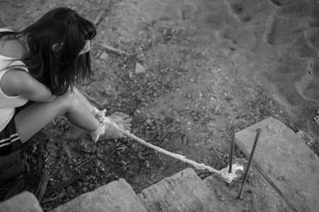 Woman bondage in angle of abandoned building , stop violence against Women, international women's dayの写真素材