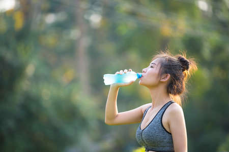 Women drink water after exercising.