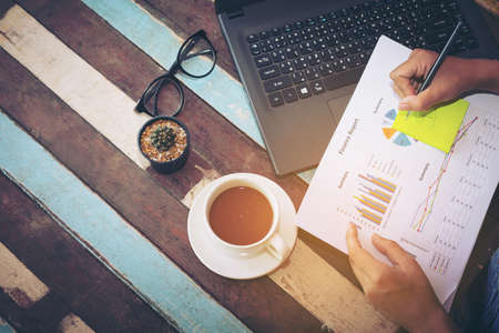 team business woman hands working and holding business graph information diagram.の写真素材