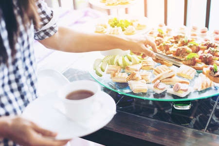 Banquet lunch break at conference meeting. Assortment of food and beverage.vintage style.の写真素材