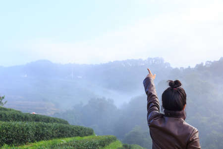 freedom girl in foggy mountains tea plantation