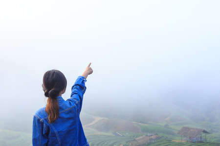 freedom girl in foggy mountains tea plantationの写真素材