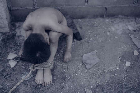 boy of a victim tied up with ropeの写真素材
