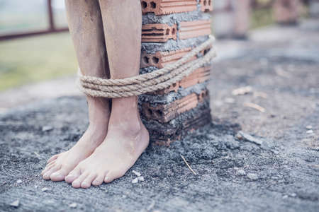 boy of a victim tied up with ropeの写真素材