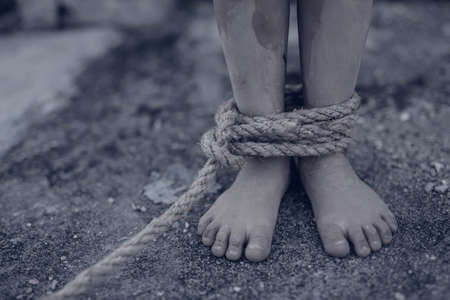 boy of a victim tied up with ropeの写真素材