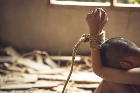 boy of a victim tied up with ropeの写真素材