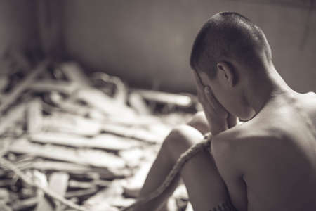 boy of a victim tied up with ropeの写真素材