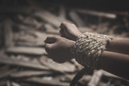 boy of a victim tied up with ropeの写真素材