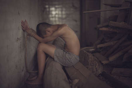 boy of a victim tied up with ropeの写真素材