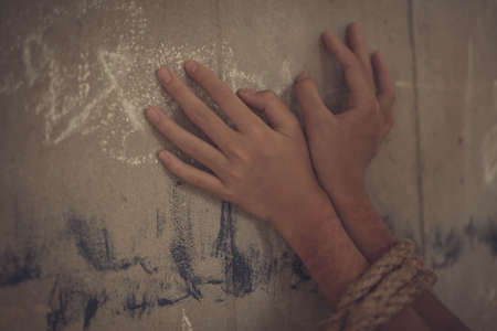 boy of a victim tied up with ropeの写真素材