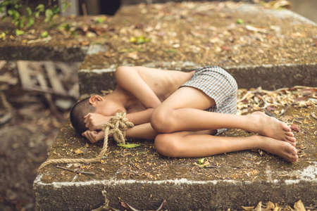 boy of a victim tied up with rope