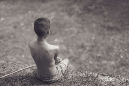 boy of a victim tied up with ropeの写真素材