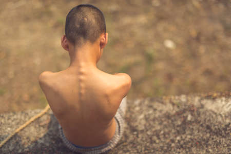 boy of a victim tied up with ropeの写真素材