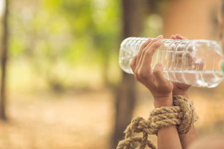 boy of a victim tied up with ropeの写真素材