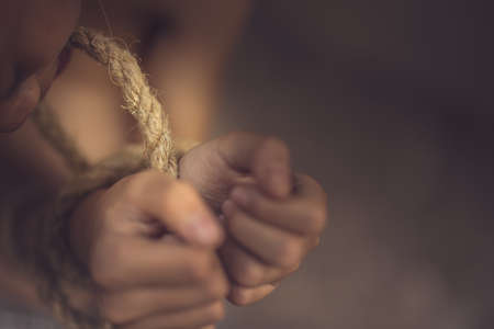 boy of a victim tied up with ropeの写真素材