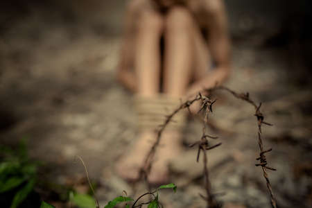 boy of a victim tied up with ropeの写真素材