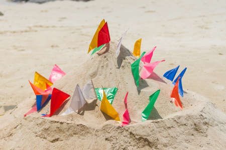 Sand Pagodas with colorful flags in Songkran Festivalの写真素材
