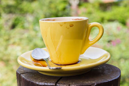Empty used coffee cup on wooden tableの写真素材