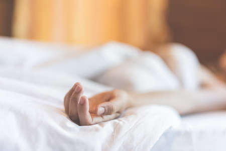 woman sit on a bed in a bedroom - concept photo of Sexual assaultの写真素材