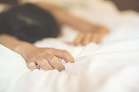 woman sit on a bed in a bedroom - concept photo of Sexual assaultの写真素材