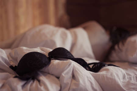 woman sit on a bed in a bedroom - concept photo of Sexual assaultの写真素材