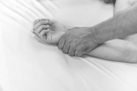 woman sit on a bed in a bedroom - concept photo of Sexual assaultの写真素材