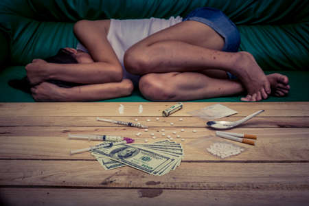 Drug addict young woman with syringe in action, Drug abuse concept.