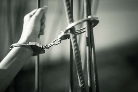 Female Hands with cage cell. trafficking Concept, focus blur.の写真素材