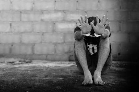 abstract of the man was bound by hand in the shackle,human traffickingの写真素材