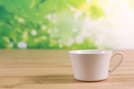 A cup of coffee on wooden stableの写真素材