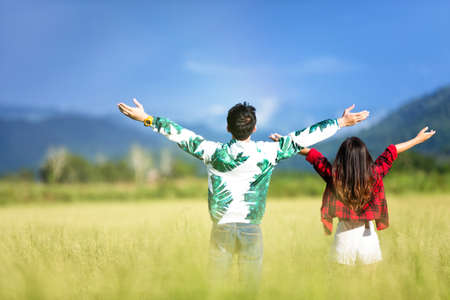 Young people are admiring nature in the meadow.