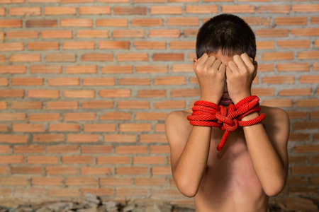 Stop abusing violence. violence, terrified , A fearful child. violence, terrified , A fearful child,Stop emotional stress and pain, afraid, restricted, trapped, call for help, struggle, terrified, violence, slave, Human Rights Day concept.の写真素材