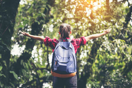 woman traveler with backpack hiking in young hiking holiday.adventure, travel, tourism.