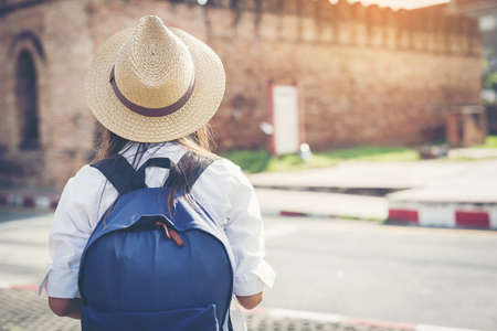 happy female tourist  searchingroad to travel on atlas in city during vacation.Travel concept.の写真素材
