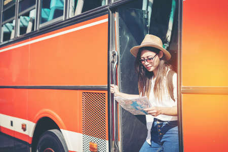 happy female tourist on map  to Bus station vacation.Travel concept.のeditorial素材