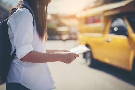 happy female tourist on map  to Bus station vacation.Travel concept.の写真素材